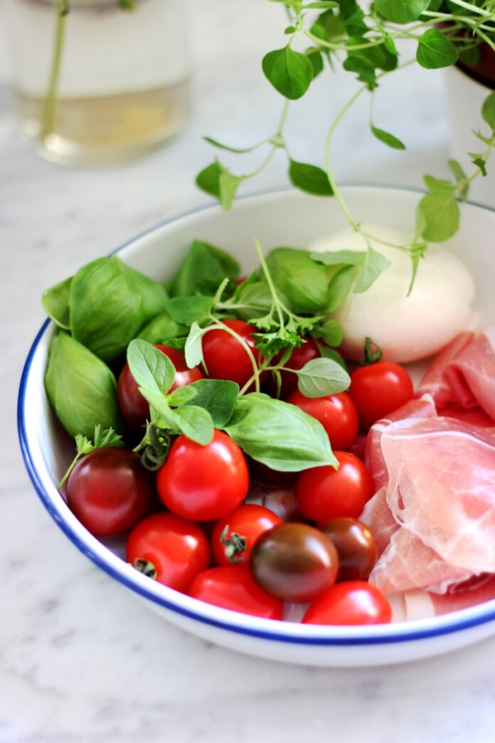 Photo by micheile henderson red tomato on bowl