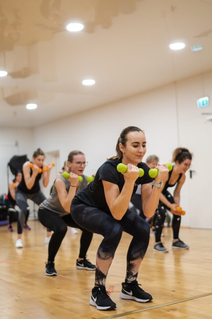 Photo by Jessica Streser A group of women doing exercises with dumbbells