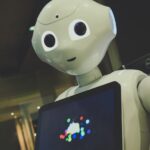 인공지능, 우리 집 건강 비서로 자리 잡다 white robot toy holding black tablet