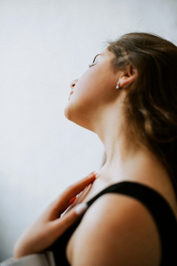 a woman with her eyes closed looking up